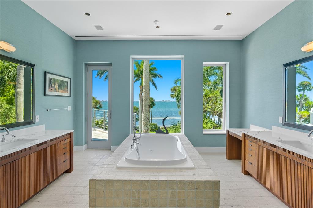 3315 Bay Shore Road Sarasota, FL 34234 - Photo 44 of 96 a spacious bedroom with a large window and a bath tub