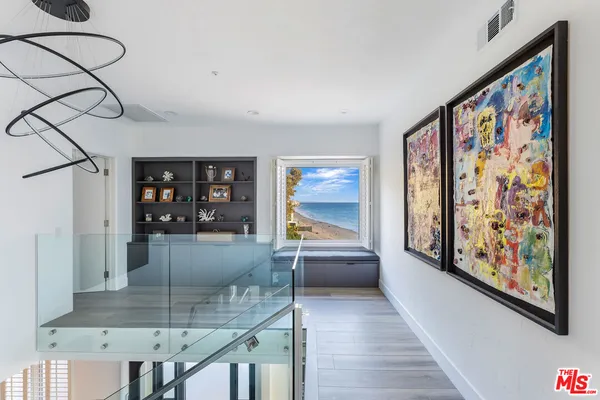 a spacious bathroom with 2 bathtub a sink and a large mirror