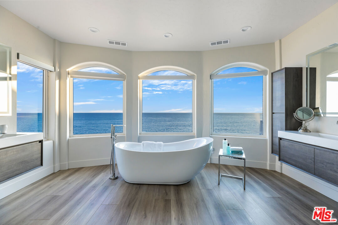 27336 Escondido Beach Road Malibu, CA 90265 - Photo 13 of 23 a spacious bathroom with 2 bathtub a sink and a large mirror