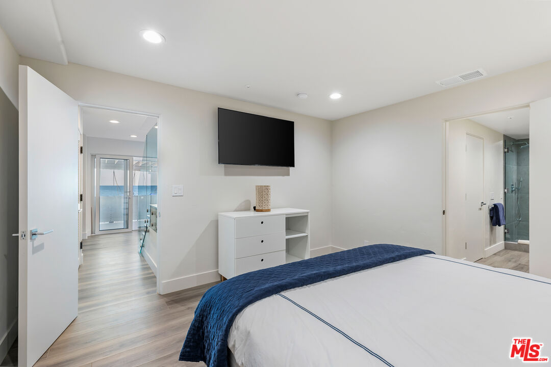27336 Escondido Beach Road Malibu, CA 90265 - Photo 19 of 23 a bedroom with a bed and a flat screen tv