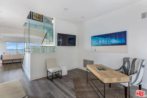 a large bedroom with wooden floor and a fireplace