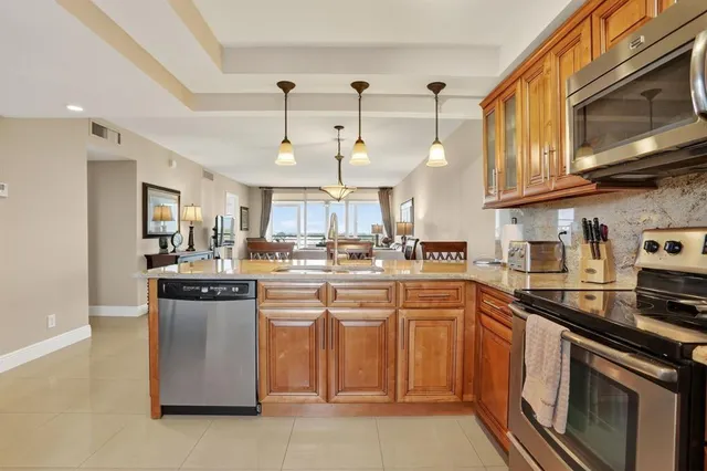 a kitchen with cabinets wooden floor and stainless steel appliances