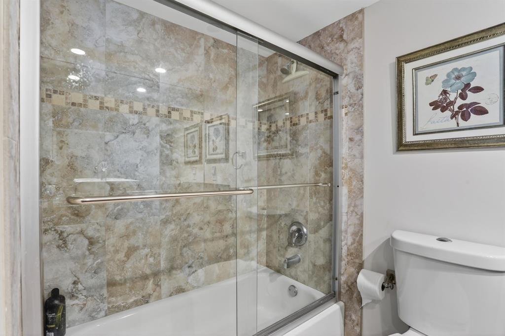 605 Oaks Drive, Unit 1008 Pompano Beach, FL 33069 - Photo 17 of 30 a bath room with a toilet and a bath tub