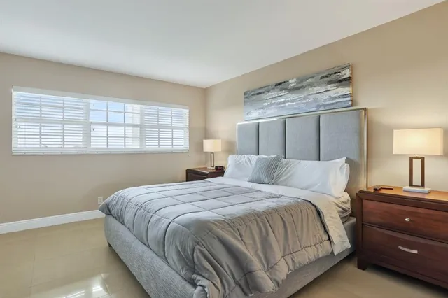 a bedroom with a bed and a lamp