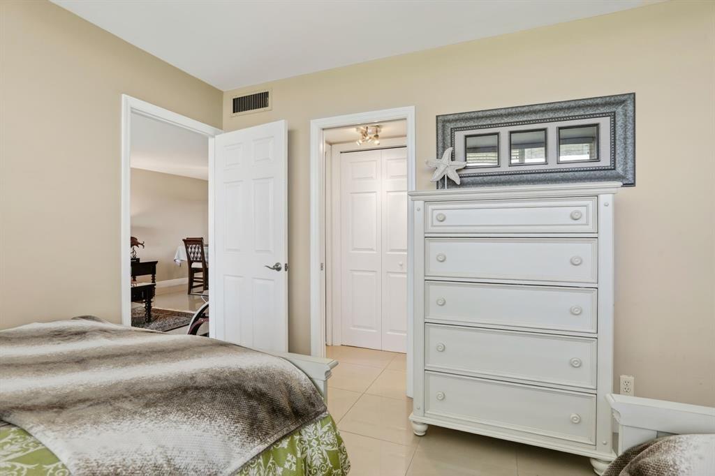 605 Oaks Drive, Unit 1008 Pompano Beach, FL 33069 - Photo 20 of 30 a bedroom with a bed and a cabinets