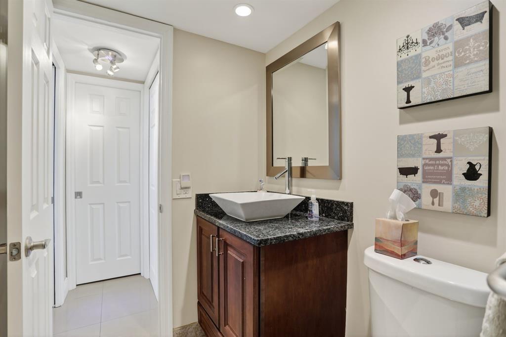 605 Oaks Drive, Unit 1008 Pompano Beach, FL 33069 - Photo 21 of 30 a bathroom with a granite countertop sink and a mirror
