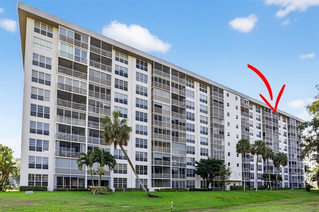 605 Oaks Drive, Unit 1008 Pompano Beach, FL 33069 - Photo 26 of 30 a view of building with yard