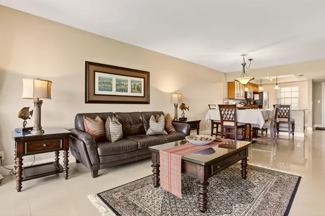 a living room with furniture and a chandelier