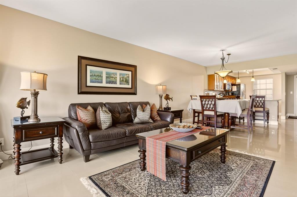 605 Oaks Drive, Unit 1008 Pompano Beach, FL 33069 - Photo 3 of 30 a living room with furniture and a chandelier