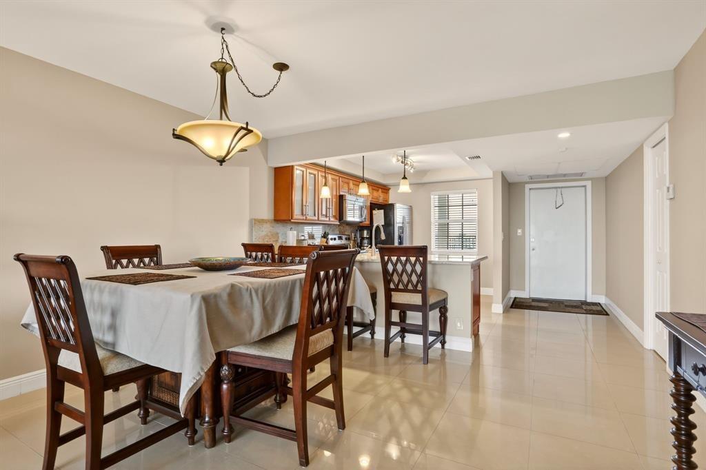 605 Oaks Drive, Unit 1008 Pompano Beach, FL 33069 - Photo 5 of 30 a view of a dining room with furniture