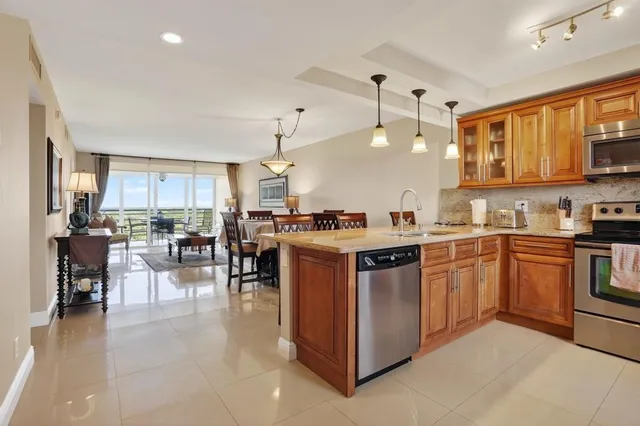 a kitchen with a sink refrigerator and cabinets
