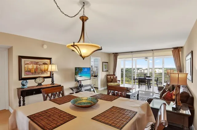 a living room with furniture and a floor to ceiling window