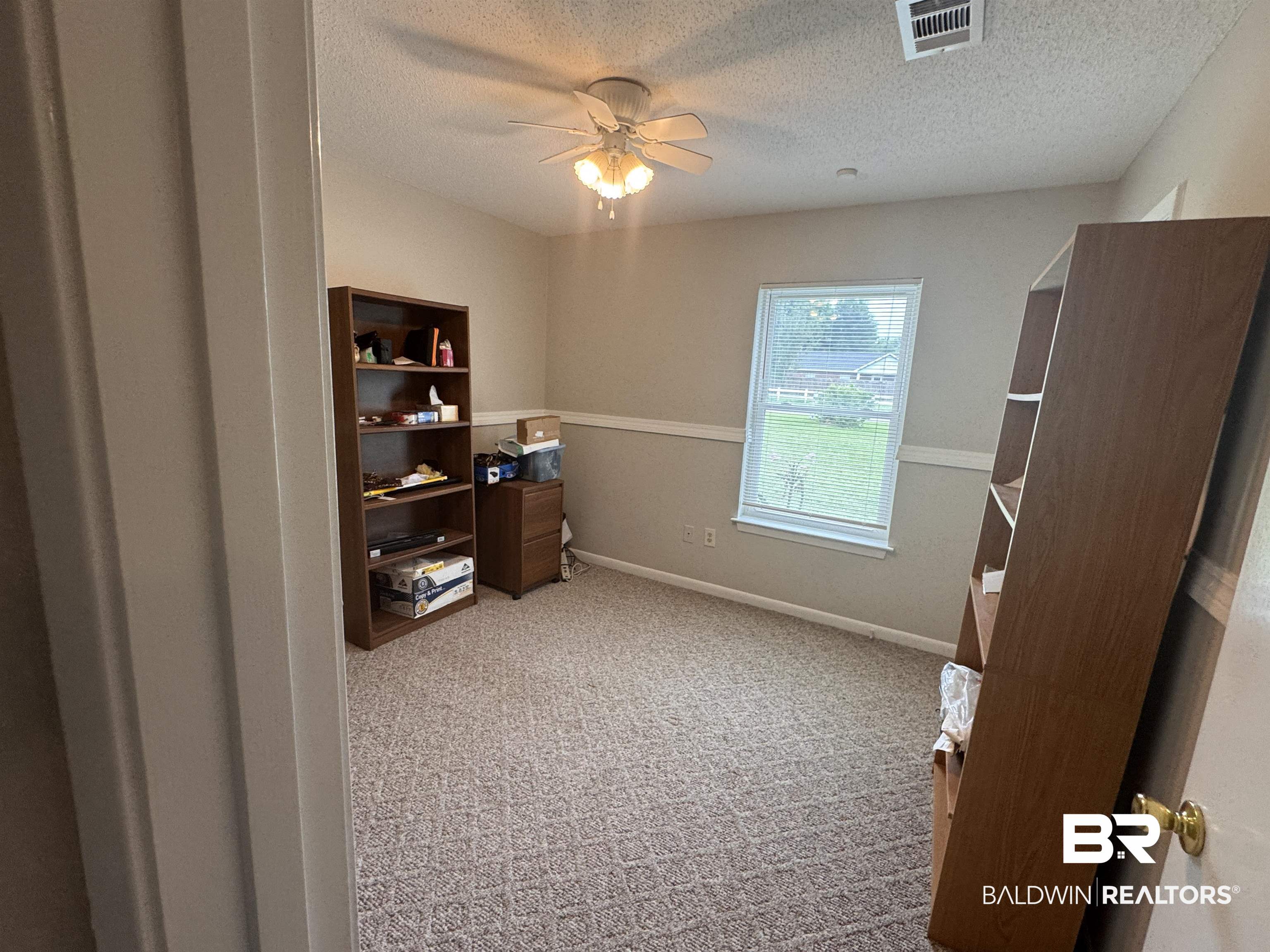 15148 Highland Circle Foley, AL 36535 - Photo 32 of 47 Office space with a textured ceiling, ceiling fan, light colored carpet, and baseboards