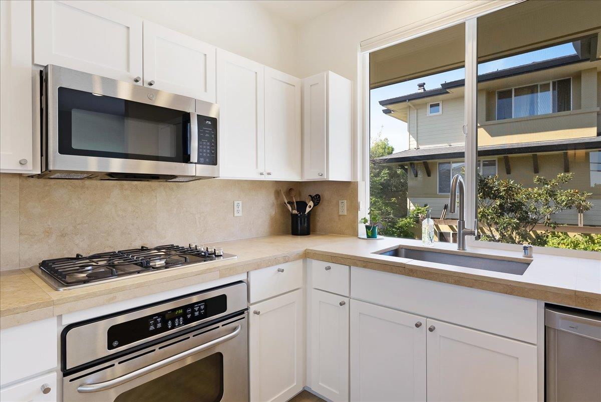 117 Gault Street, Unit B Santa Cruz, CA 95062 - Photo 16 of 42 a kitchen with stainless steel appliances white cabinets and a stove top oven
