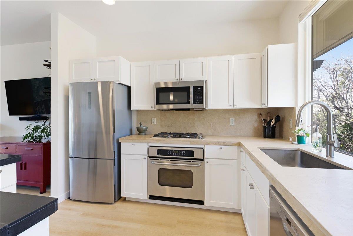 117 Gault Street, Unit B Santa Cruz, CA 95062 - Photo 17 of 42 a kitchen with a refrigerator stove and microwave