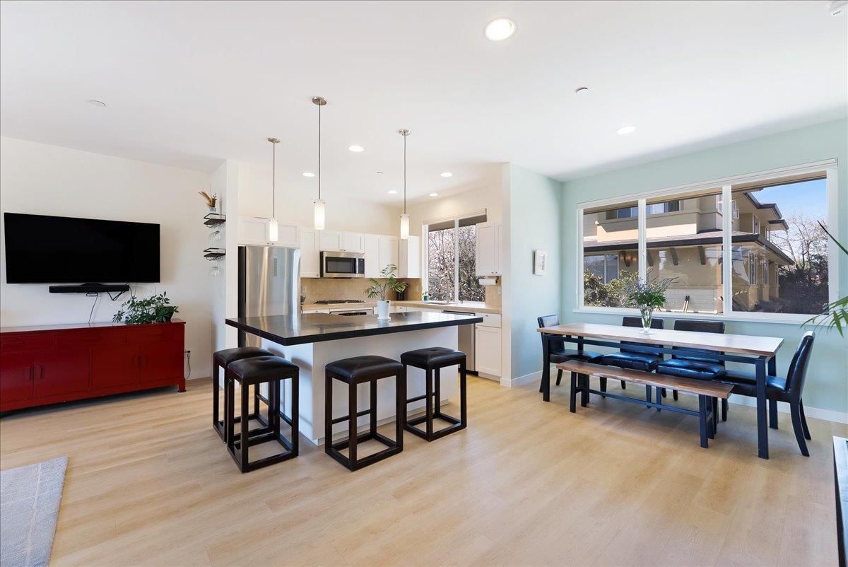 117 Gault Street, Unit B Santa Cruz, CA 95062 - Photo 8 of 42 a room with stainless steel appliances kitchen island granite countertop furniture and a flat screen tv