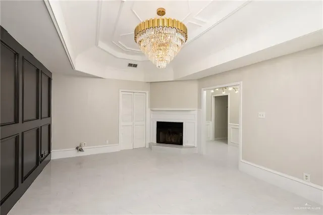 a view of an empty room with a fireplace