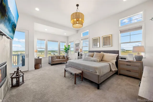 a living room with furniture and a floor to ceiling window