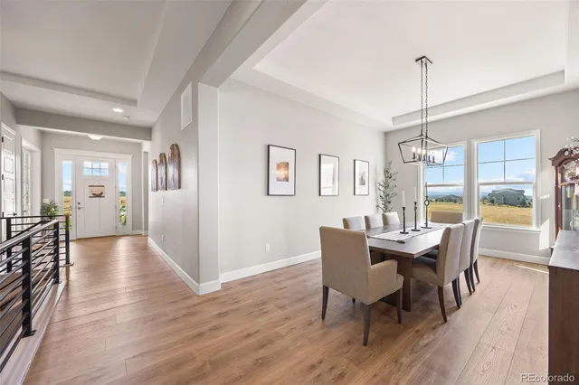 a kitchen with stainless steel appliances granite countertop a sink a stove and a wooden floors