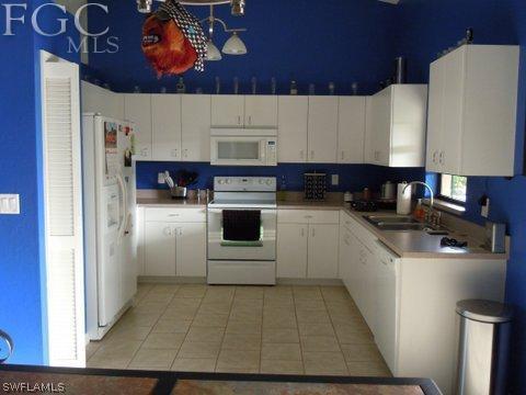 17552 Ingram Road Fort Myers, FL 33967 - Photo 2 of 5 a kitchen with a sink a stove and cabinets