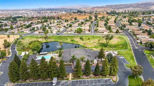 an aerial view of residential building with parking and yard