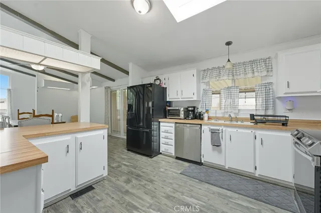 a kitchen with a refrigerator stove and sink