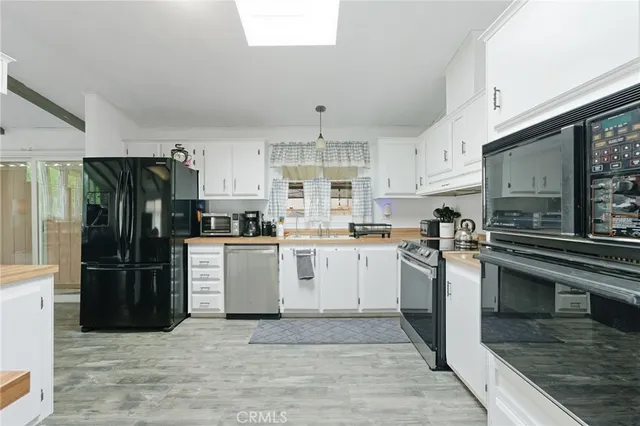 a kitchen with stainless steel appliances granite countertop a stove and a refrigerator