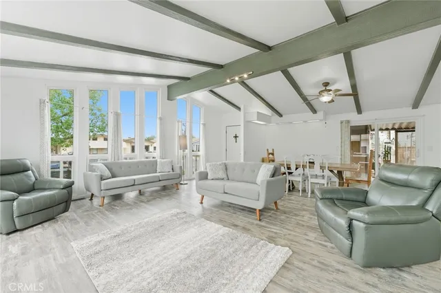 a view of a dining room with furniture and a flat screen tv