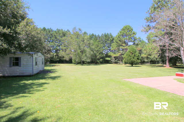 16809 River Park Road Fairhope, AL 36532 - Photo 5 of 18 Note the storage shed for all lawn tools. Yes you can drive your rider in there.