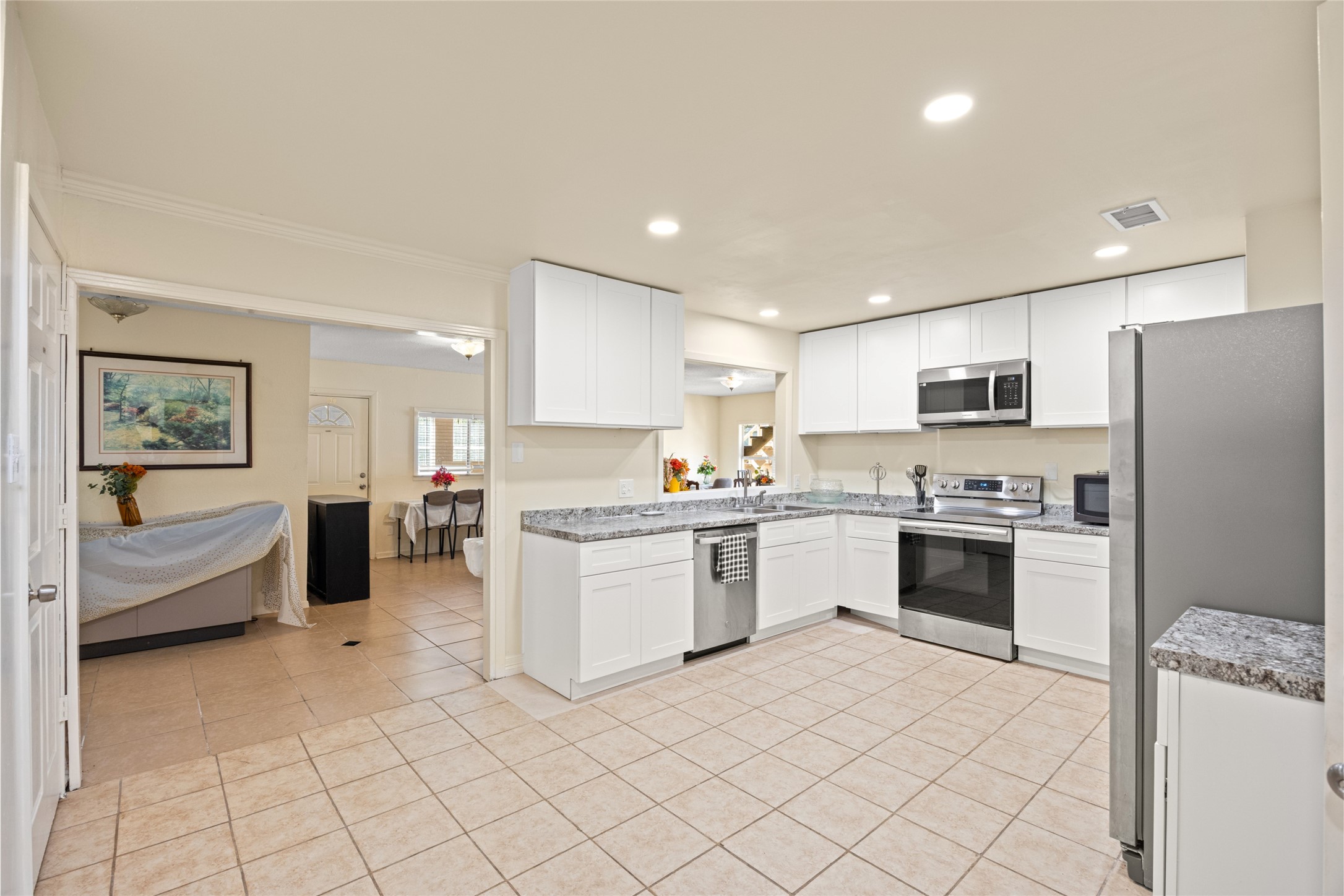 25231 Roesner Lane Katy, TX 77494 - Photo 13 of 48 a kitchen with a sink a counter top space stainless steel appliances and cabinets