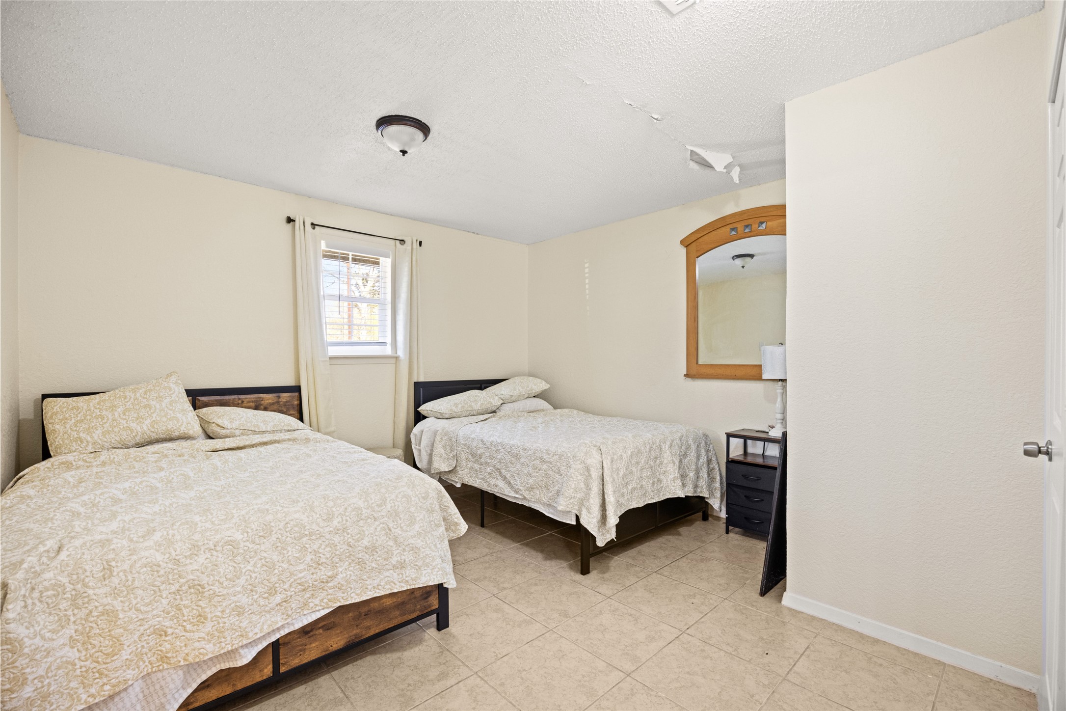 25231 Roesner Lane Katy, TX 77494 - Photo 22 of 48 a bedroom with two beds and a window