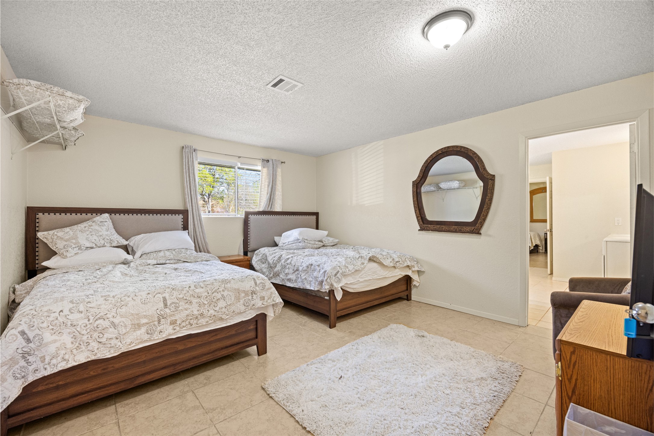 25231 Roesner Lane Katy, TX 77494 - Photo 26 of 48 a bedroom with bed and a large mirror on the dresser
