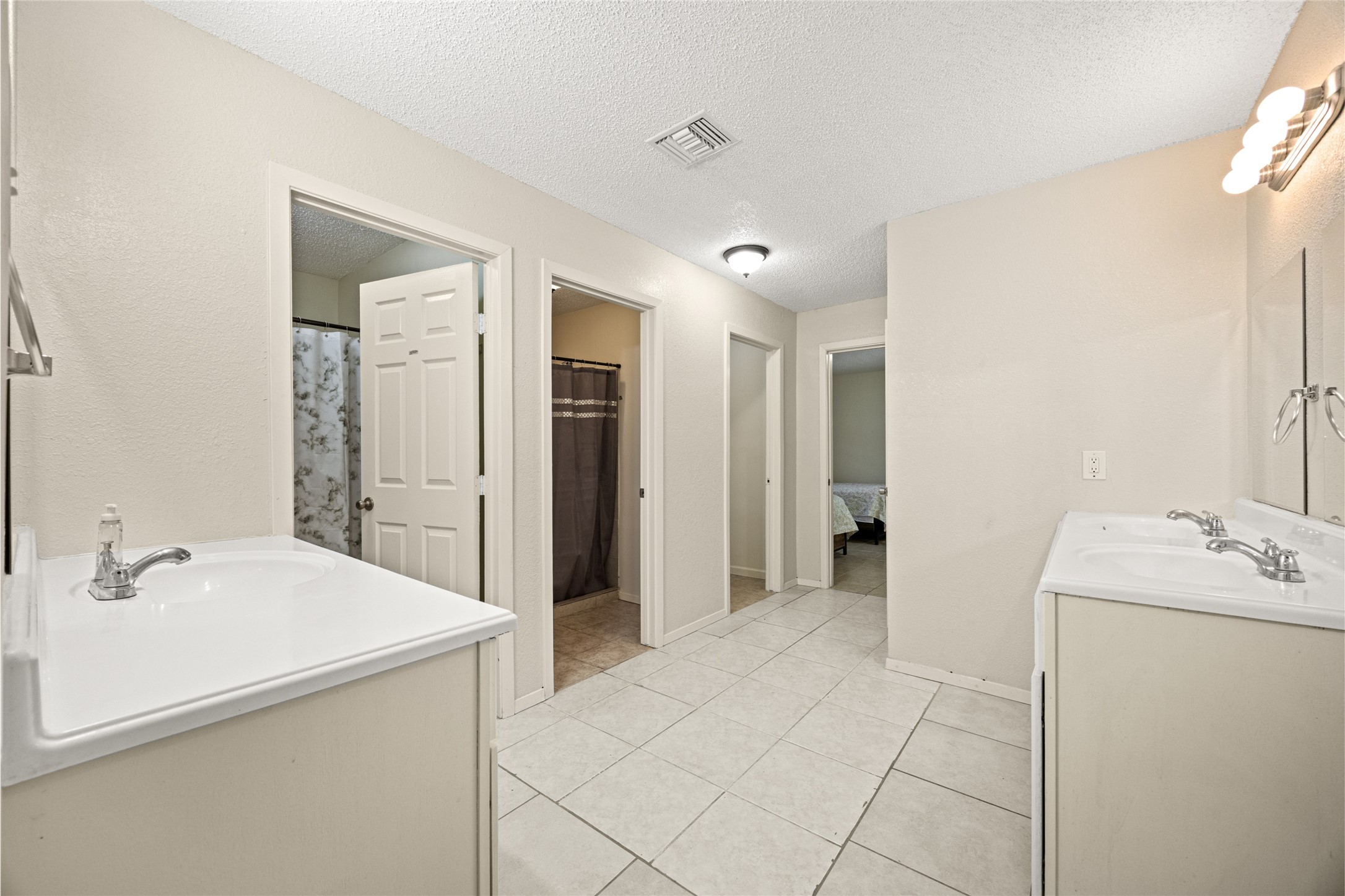 25231 Roesner Lane Katy, TX 77494 - Photo 38 of 48 a bathroom with a sink a mirror and a shower