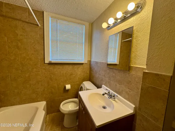 a bathroom with a sink mirror and toilet
