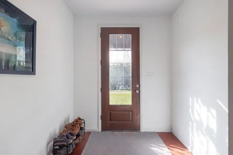 a kitchen with stainless steel appliances a table and chairs in it