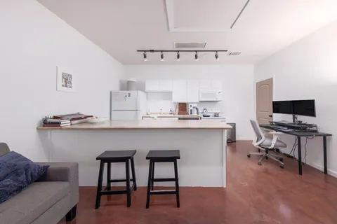 a kitchen with a stove sink and refrigerator