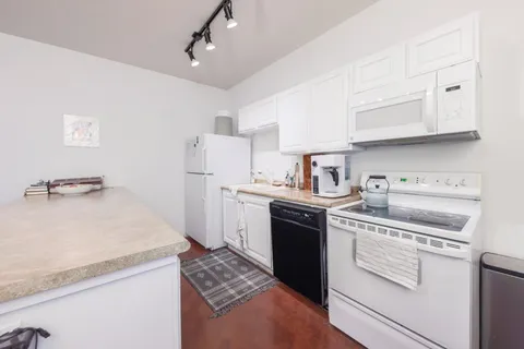 a kitchen with a sink stove and refrigerator