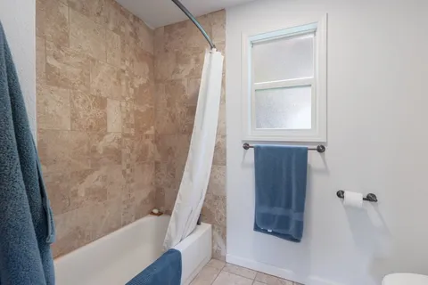a bathroom with a granite countertop toilet sink and mirror