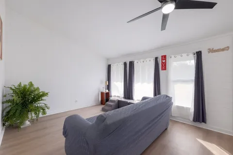 a living room with furniture window and wooden floor