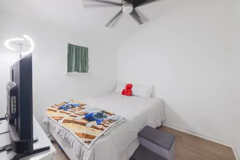 a bedroom with a bed and a table in it