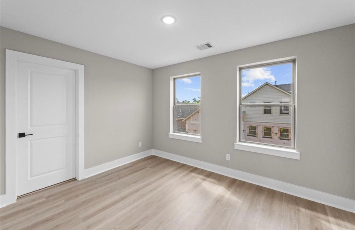 2606 Liguria Ln Spring Spring, TX 77388 - Photo 17 of 29 a view of an empty room with wooden floor and window