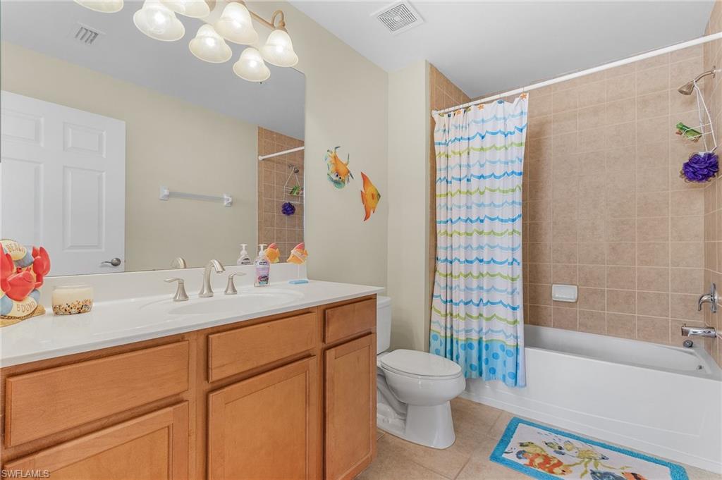 3732 Pino Vista Way, Unit 2 Estero, FL 33928 - Photo 13 of 29 a bathroom with a sink toilet and shower