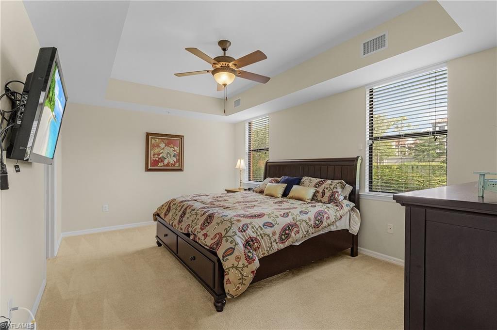 3732 Pino Vista Way, Unit 2 Estero, FL 33928 - Photo 17 of 29 a bedroom with a bed and a flat screen tv