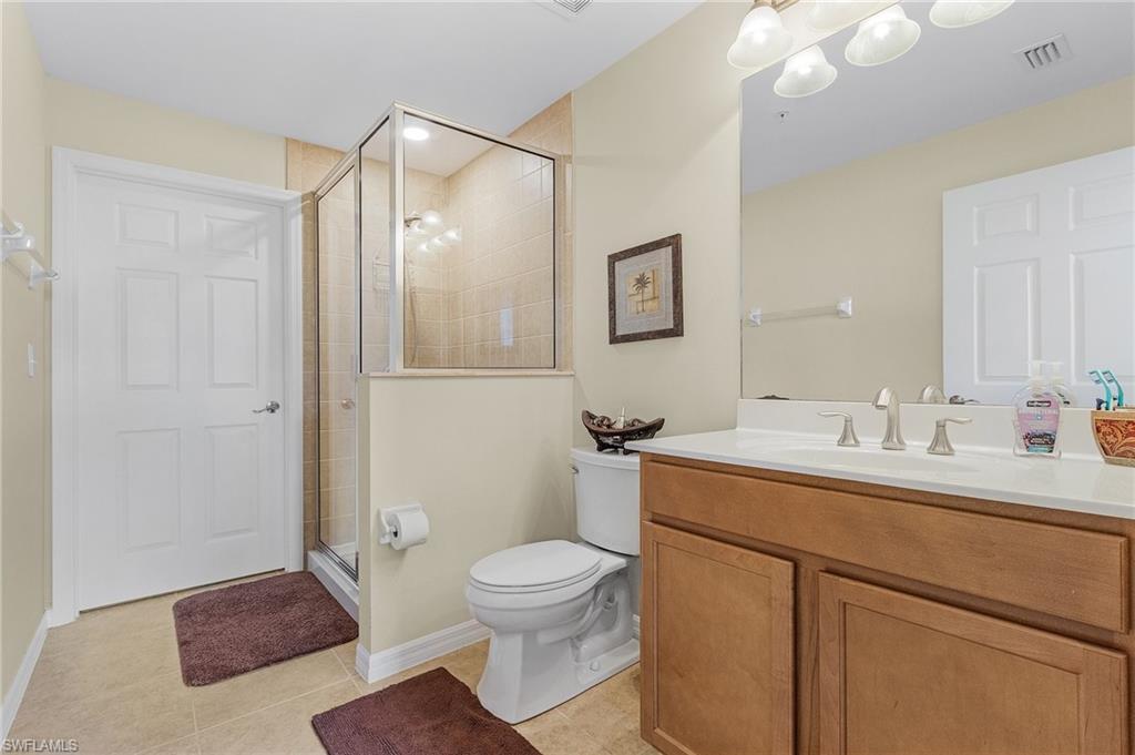3732 Pino Vista Way, Unit 2 Estero, FL 33928 - Photo 19 of 29 a bathroom with a toilet a sink and mirror