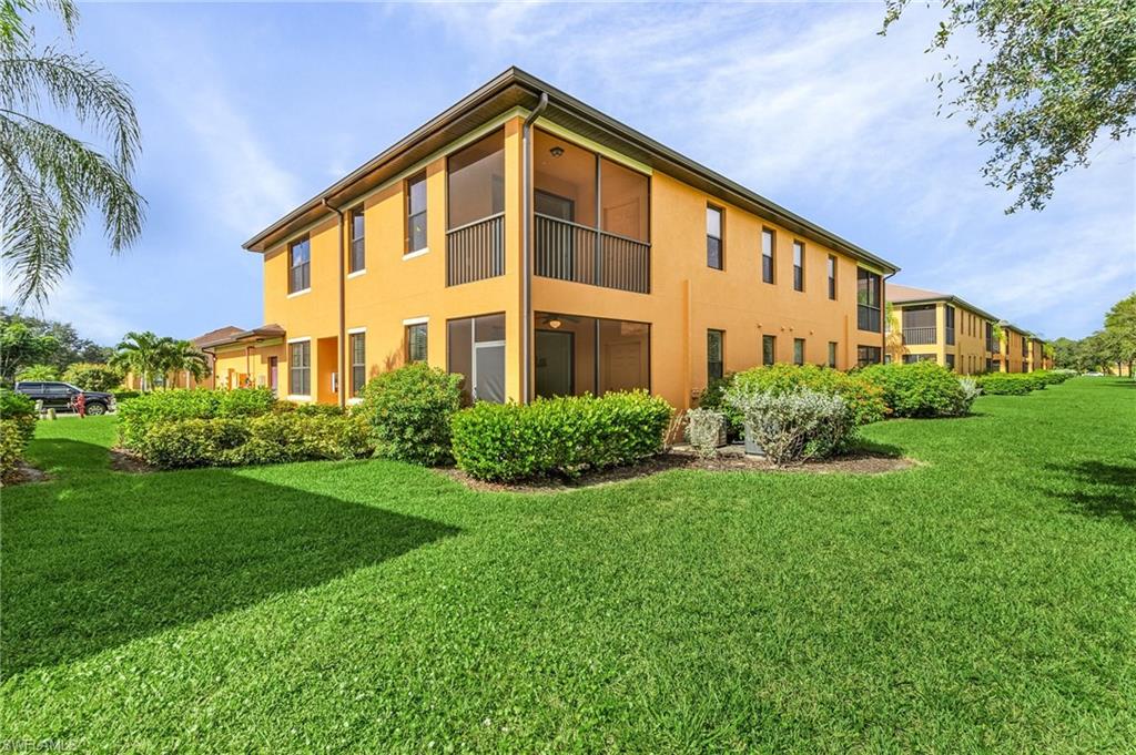 3732 Pino Vista Way, Unit 2 Estero, FL 33928 - Photo 2 of 29 a front view of a house with a yard