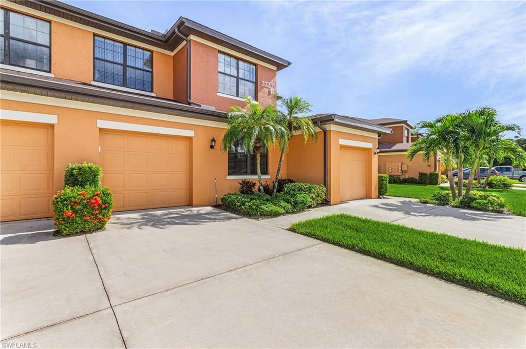 3732 Pino Vista Way, Unit 2 Estero, FL 33928 - Photo 22 of 29 a front view of a house with garden
