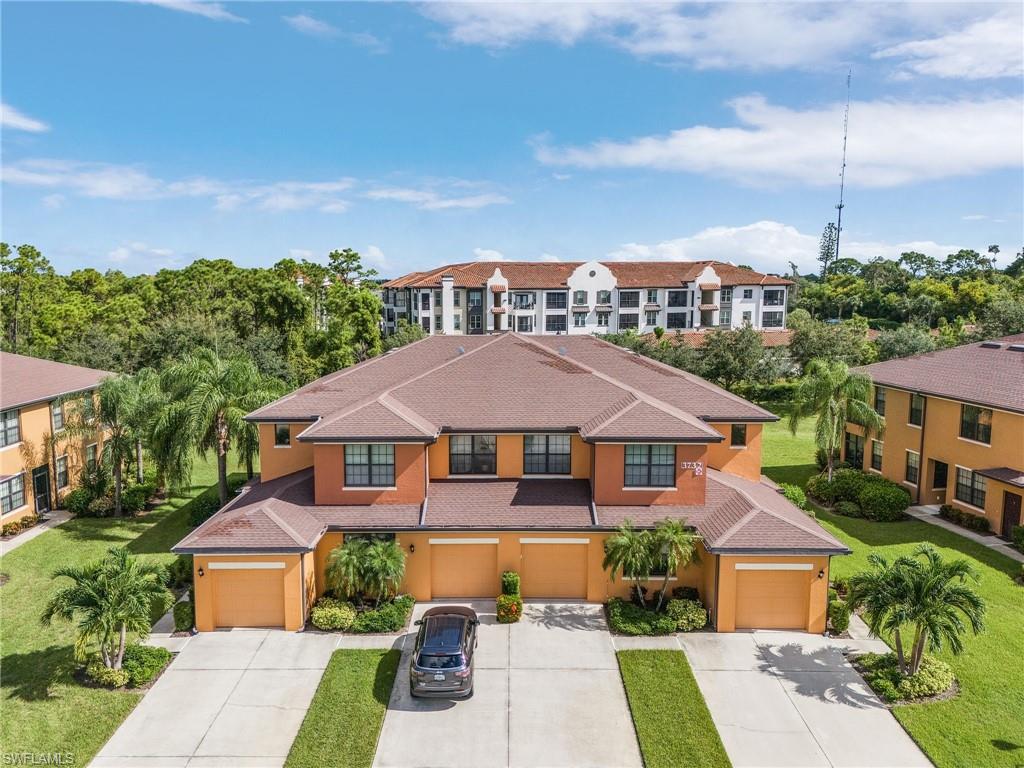 3732 Pino Vista Way, Unit 2 Estero, FL 33928 - Photo 23 of 29 a front view of a house with a yard