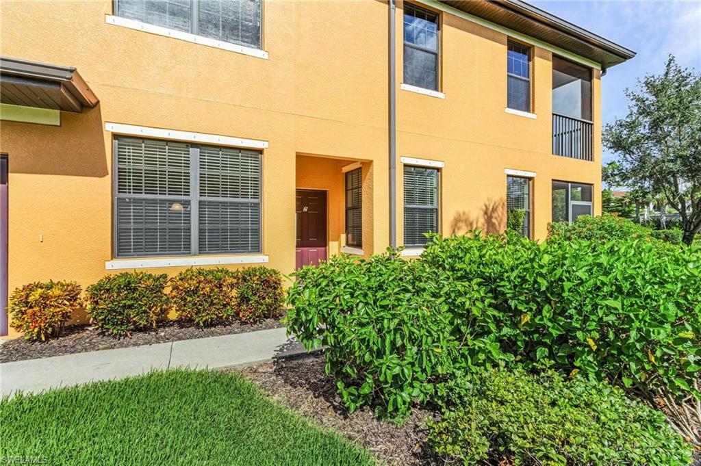 3732 Pino Vista Way, Unit 2 Estero, FL 33928 - Photo 25 of 29 a front view of a house with a garden