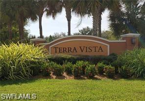 3732 Pino Vista Way, Unit 2 Estero, FL 33928 - Photo 29 of 29 a sign of golf club on a wall under a tree