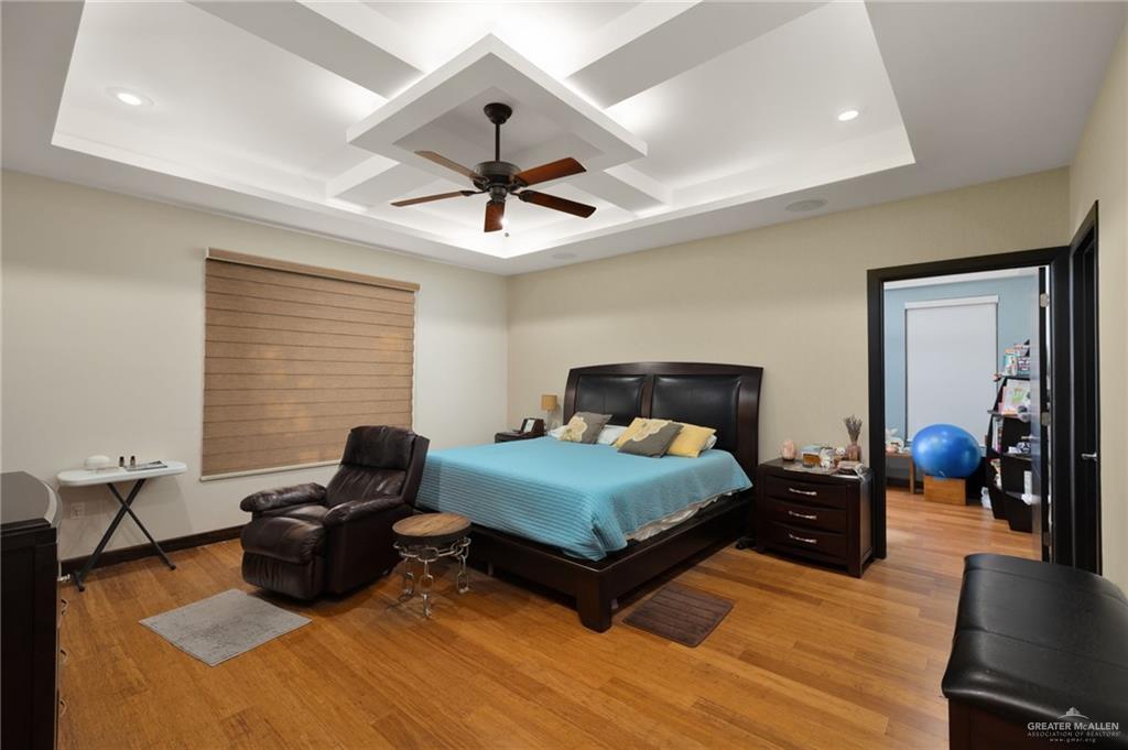 809 Rio Grande Drive Mission, TX 78572 - Photo 13 of 45 a bedroom with a bed and wooden floor